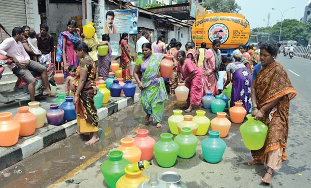 Women rushing to fill their plastic pots with water. Women rushing to fill their plastic pots with water.